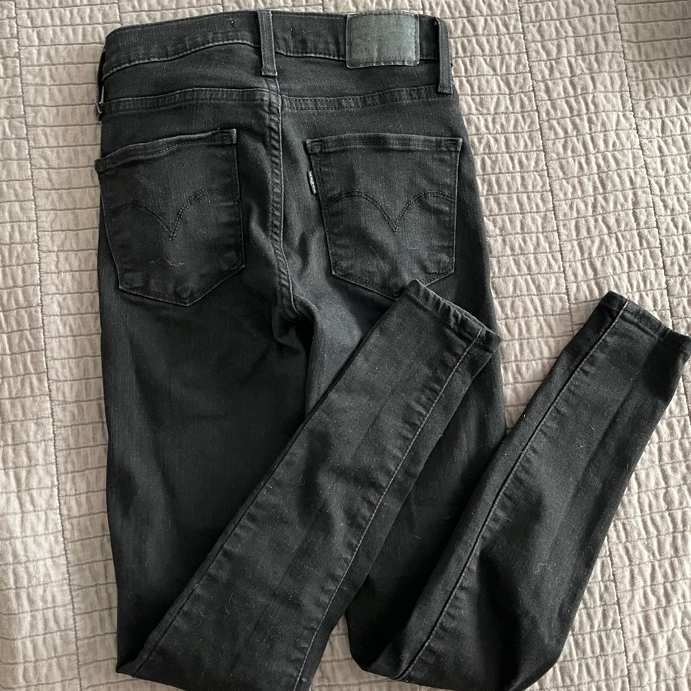 Levi’s black 420 high raise super skinny jeans.
